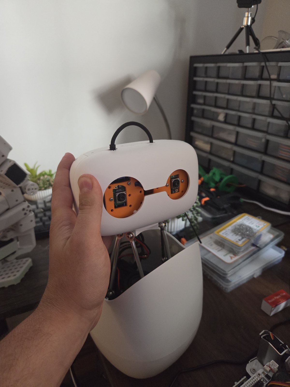 Reachy Mini head opened to show a camera in each eye on a custom mount and modified PCB